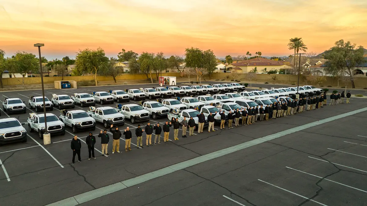 greenleaf team standing outside with their trucks