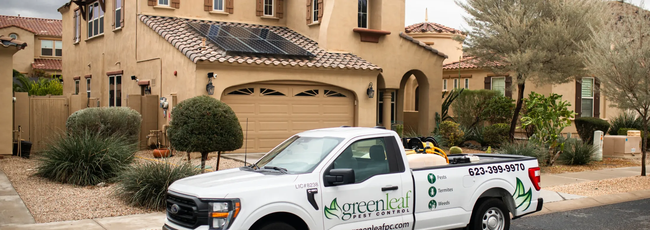 Greenleaf pest control tech servicing a home