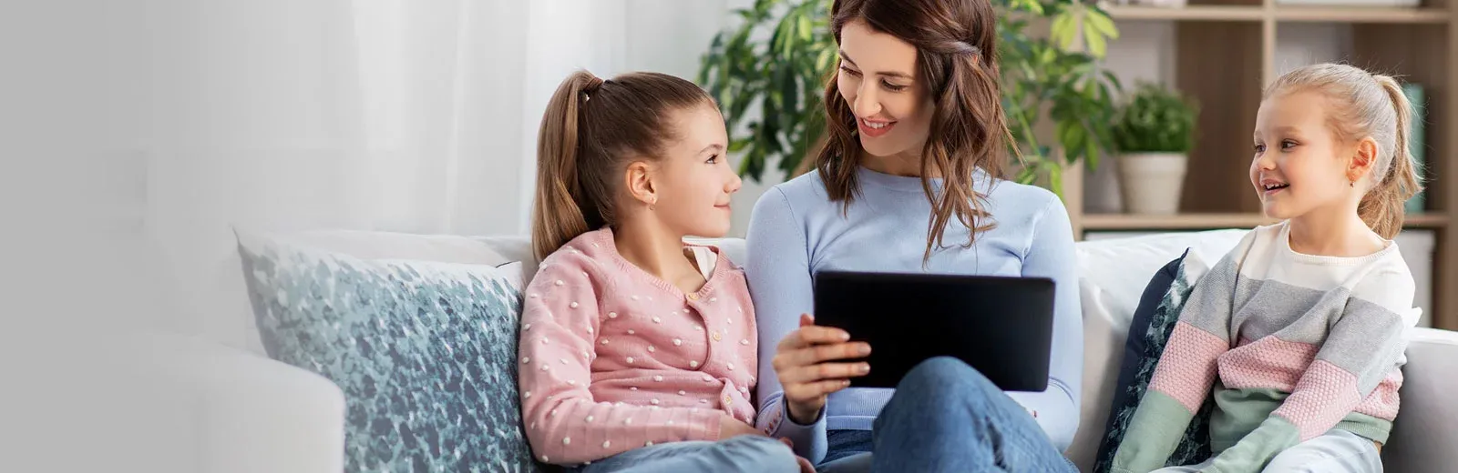 Mom and daughers lauging in living room